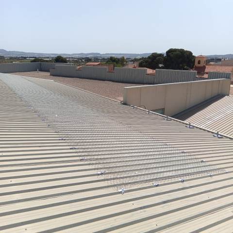 Instalación de malla de seguridad sobre lucernarios en nave industrial